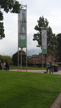 Towers displaying banners of Brushes With War art in front of the Kelvingrove Art Gallery and Museum, Glasgow, Scotland